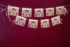 Corn husk papel picado by Ay Mujer. Mariposa design  cut into hojas de maiz and strung into banner art.