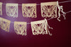 Corn husk papel picado by Ay Mujer. Mariposa design  cut into hojas de maiz and strung into banner art.