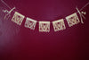 Corn husk papel picado by Ay Mujer. Mariposa design  cut into hojas de maiz and strung into banner art.